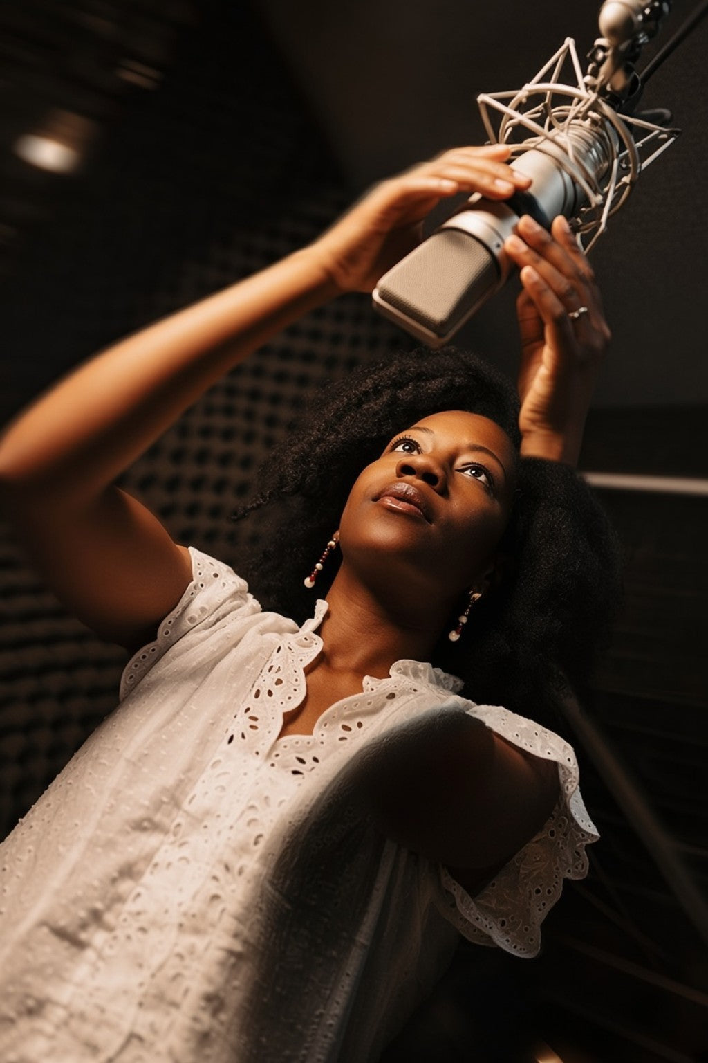 Afrobeats artist recording vocals at a studio microphone