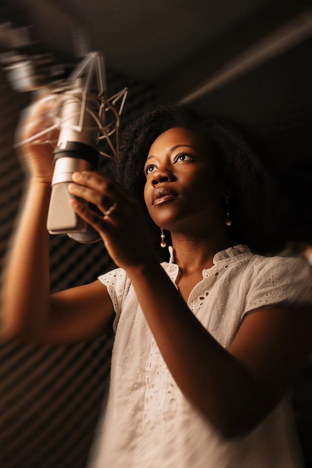 Afrobeats artist recording in an acoustic studio booth