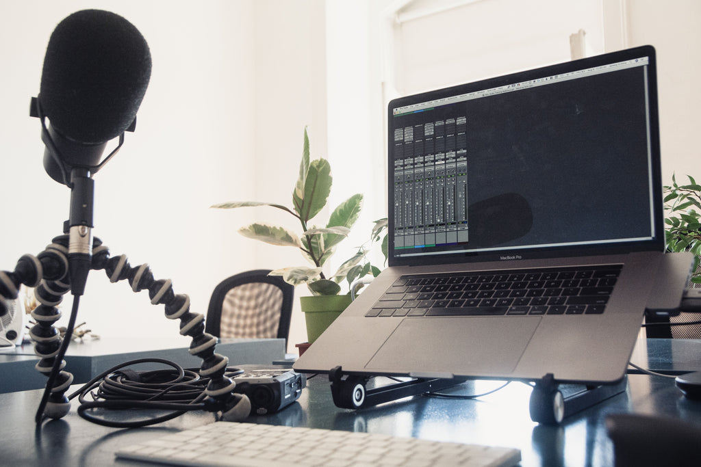 Home recording studio with laptop and microphone for audio production
