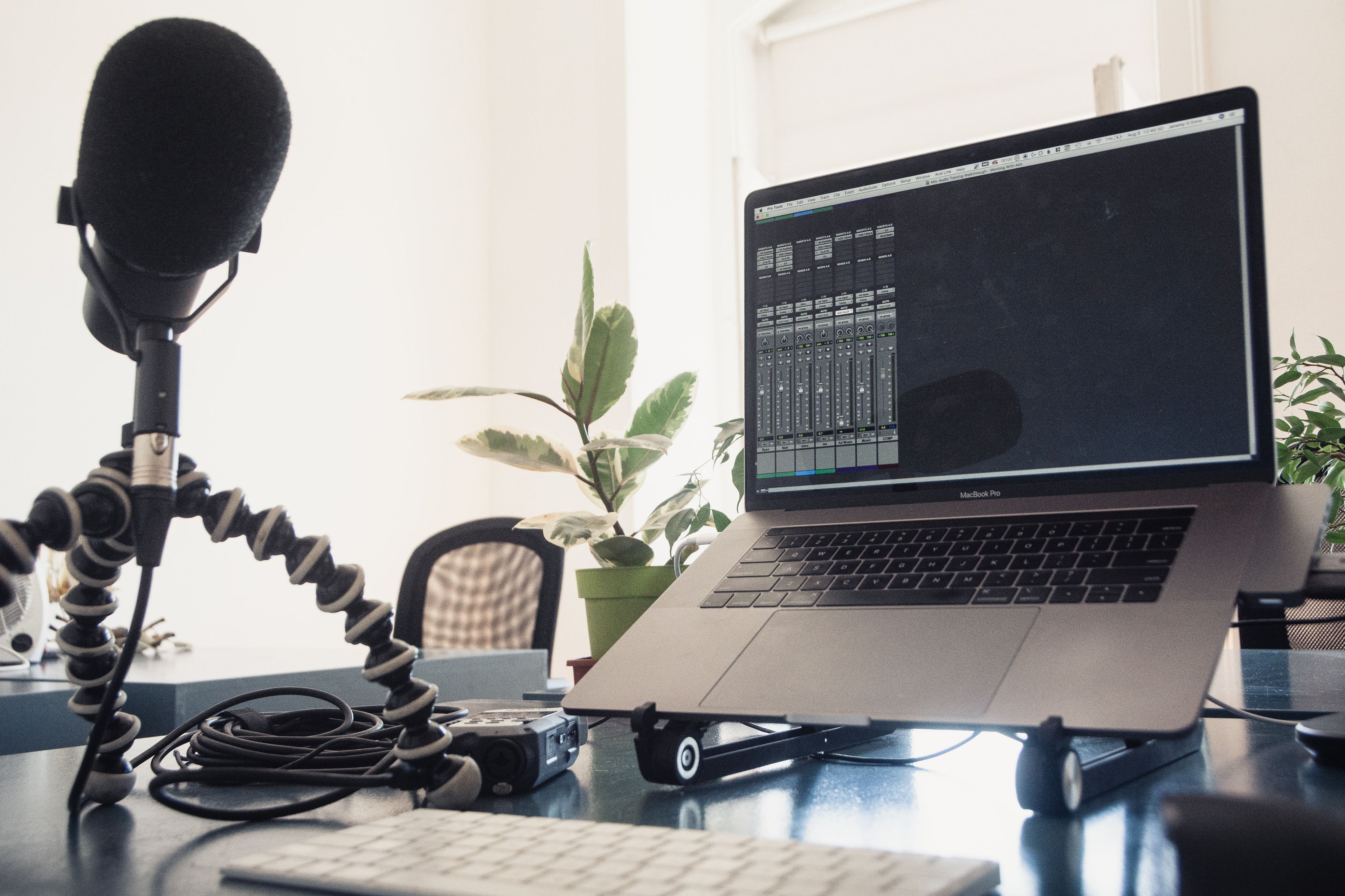 Home recording studio with laptop and microphone for audio production